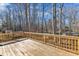 Expansive wooden deck surrounded by trees and lush greenery, ideal for outdoor living at 612 Miller Rd, Hillsborough, NC 27278