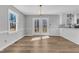 Bright dining area with white trim, French doors to the deck, and a view into the kitchen at 612 Miller Rd, Hillsborough, NC 27278