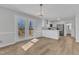 Bright, airy kitchen with french doors to deck, with sleek white cabinetry, and stainless steel appliances at 612 Miller Rd, Hillsborough, NC 27278