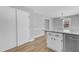 Open kitchen with breakfast bar, stainless steel dishwasher, and wood flooring at 612 Miller Rd, Hillsborough, NC 27278