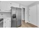 Kitchen featuring stainless steel refrigerator, white cabinets, and wood flooring at 612 Miller Rd, Hillsborough, NC 27278