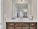 A bathroom with a large mirror above a single vanity, providing ample light and functionality at 640 Newlyn Dr, Raleigh, NC 27606