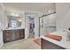 Modern bathroom featuring dual vanities, a glass-enclosed shower, and a walk-in closet at 640 Newlyn Dr, Raleigh, NC 27606