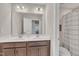 Bathroom featuring double sink vanity, neutral walls, and framed mirror at 640 Newlyn Dr, Raleigh, NC 27606