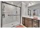 Modern bathroom with a spacious glass-enclosed shower and a single vanity with a large mirror at 640 Newlyn Dr, Raleigh, NC 27606