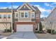 Charming townhome featuring a two-car garage and well-maintained landscaping, complete with a brick and siding exterior at 640 Newlyn Dr, Raleigh, NC 27606