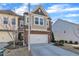 A well-maintained townhome featuring a two-car garage, siding exterior and a concrete driveway at 640 Newlyn Dr, Raleigh, NC 27606