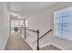 Bright upstairs hallway with natural light and access to carpeted stairs and bedrooms at 640 Newlyn Dr, Raleigh, NC 27606