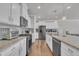 Expansive kitchen with white cabinets, granite countertops, stainless steel appliances, and hardwood floors at 640 Newlyn Dr, Raleigh, NC 27606