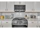 Close up of a kitchen with stainless appliances and neutral backsplash at 640 Newlyn Dr, Raleigh, NC 27606