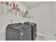 Laundry room with front load washer and dryer and wire shelving at 640 Newlyn Dr, Raleigh, NC 27606