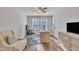Comfortable home office with a ceiling fan, hardwood floors, and ample natural light at 640 Newlyn Dr, Raleigh, NC 27606