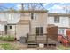 View of the back of this townhome with a wood deck and exterior in a neutral color at 6734 Chauncey Dr, Raleigh, NC 27615