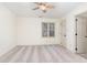 Bright bedroom featuring a ceiling fan, neutral carpet, and a window with natural light at 6734 Chauncey Dr, Raleigh, NC 27615