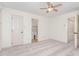 Spacious bedroom offering neutral carpet, ceiling fan, and access to an ensuite bathroom at 6734 Chauncey Dr, Raleigh, NC 27615
