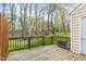 Back deck surrounded by trees with lush green lawn in the background at 6734 Chauncey Dr, Raleigh, NC 27615