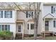 Charming townhouse featuring light siding and a welcoming front entrance with a well maintained front yard at 6734 Chauncey Dr, Raleigh, NC 27615