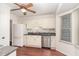 Well-lit kitchen with white cabinets, modern appliances, and a view into the dining area for easy access at 6734 Chauncey Dr, Raleigh, NC 27615