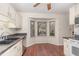 Bright kitchen with white cabinets, stainless steel appliances, and a large bay window overlooking the neighborhood at 6734 Chauncey Dr, Raleigh, NC 27615