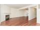 Spacious living area with hardwood floors, a fireplace, and a ceiling fan, open to the kitchen at 6734 Chauncey Dr, Raleigh, NC 27615