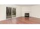 Bright living room with fireplace, hardwood floors, and sliding glass doors leading to a deck at 6734 Chauncey Dr, Raleigh, NC 27615