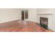 Living room featuring hardwood floors, sliding glass doors, and a fireplace, creating a warm and inviting atmosphere at 6734 Chauncey Dr, Raleigh, NC 27615