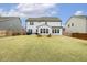 Expansive backyard features a well-manicured lawn, wooden Adirondack chairs, and a privacy fence at 705 Marshall Farm St, Wake Forest, NC 27587