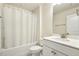 Bright bathroom with a tub and shower combo, a white shower curtain, and vanity with white cabinets at 705 Marshall Farm St, Wake Forest, NC 27587