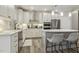 Stylish kitchen with stainless steel appliances, quartz countertops, and a kitchen island with seating at 705 Marshall Farm St, Wake Forest, NC 27587