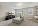 Living area features a comfy couch, a TV on a stand, a carpet, and lots of natural light from the windows at 705 Marshall Farm St, Wake Forest, NC 27587