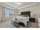 Cozy bedroom with a tray ceiling, large window, and a comfortable queen-sized bed at 705 Marshall Farm St, Wake Forest, NC 27587