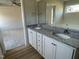 Bathroom featuring double sinks, granite counters, and a separate tub and shower at 77 Heatherglenn Cir, Princeton, NC 27569