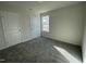 Carpeted bedroom with natural light from a window, and a closet at 77 Heatherglenn Cir, Princeton, NC 27569