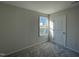 Carpeted bedroom with a bright window, and white door at 77 Heatherglenn Cir, Princeton, NC 27569