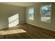 Bright bedroom features wood flooring and two large windows offering natural light at 77 Heatherglenn Cir, Princeton, NC 27569