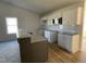 Well-lit kitchen featuring granite counters, stainless appliances, and a breakfast bar at 77 Heatherglenn Cir, Princeton, NC 27569