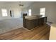 Open-concept kitchen featuring a granite island with sink overlooking the living area at 77 Heatherglenn Cir, Princeton, NC 27569