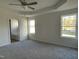 Spacious primary bedroom featuring a tray ceiling, a ceiling fan, and an ensuite bathroom at 77 Heatherglenn Cir, Princeton, NC 27569