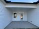 View of a covered patio with concrete flooring, a window, and a glass door at 77 Heatherglenn Cir, Princeton, NC 27569