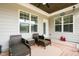 Covered back porch with wicker furniture and outdoor decor at 81 N Lumina Ln, Clayton, NC 27527
