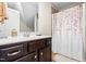 Bathroom with a dark wood vanity and a floral shower curtain at 81 N Lumina Ln, Clayton, NC 27527