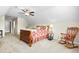 Cozy bedroom featuring a floral comforter and a vintage rocking chair at 81 N Lumina Ln, Clayton, NC 27527