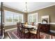 Inviting dining room featuring an elegant chandelier, plantation shutters, and a stylish area rug at 81 N Lumina Ln, Clayton, NC 27527