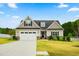 Charming two-story home with a well-manicured lawn and a two-car garage at 81 N Lumina Ln, Clayton, NC 27527