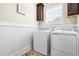 Functional laundry room with washer, dryer, beadboard, and built-in cabinets for ample storage at 81 N Lumina Ln, Clayton, NC 27527