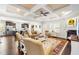 Open-concept living room boasts a coffered ceiling, fireplace, and seamless transition to the modern kitchen at 81 N Lumina Ln, Clayton, NC 27527