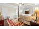 Spacious main bedroom suite with tray ceiling, four-poster bed, and hardwood flooring at 81 N Lumina Ln, Clayton, NC 27527