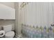 Bathroom showcasing a toilet, shower with decorative curtain and medicine cabinet at 834 November Ln, Willow Springs, NC 27592