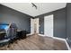 This bedroom features wood-look floors, dark gray walls, and an entrance to another room at 834 November Ln, Willow Springs, NC 27592
