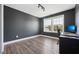 Bedroom featuring wood-look floors, a window with natural light, and a dark accent wall at 834 November Ln, Willow Springs, NC 27592